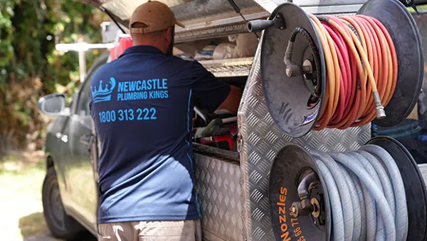 Plumber collecting gear from the ute toolbox